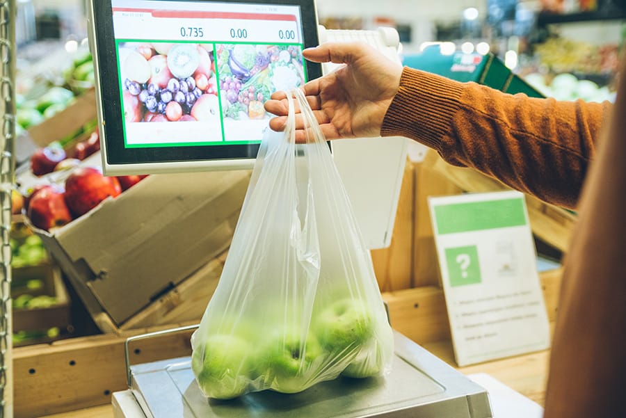 man weigh fruits on digital scales. shopping concept