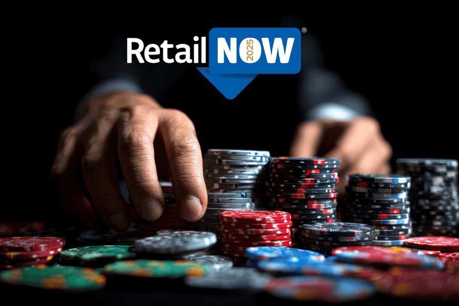 Close-up of hands stacking casino chips at a dark poker table, symbolizing high-stakes decisions at RetailNOW! 2025.