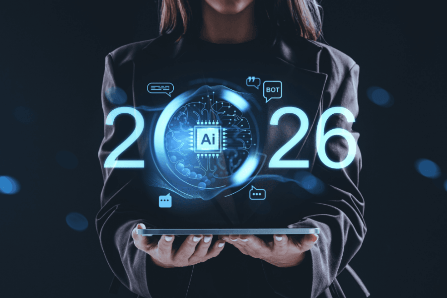A business professional holds a digital tablet displaying a glowing AI interface with the numbers 2026, symbolizing the rapid evolution of technology trends and artificial intelligence.